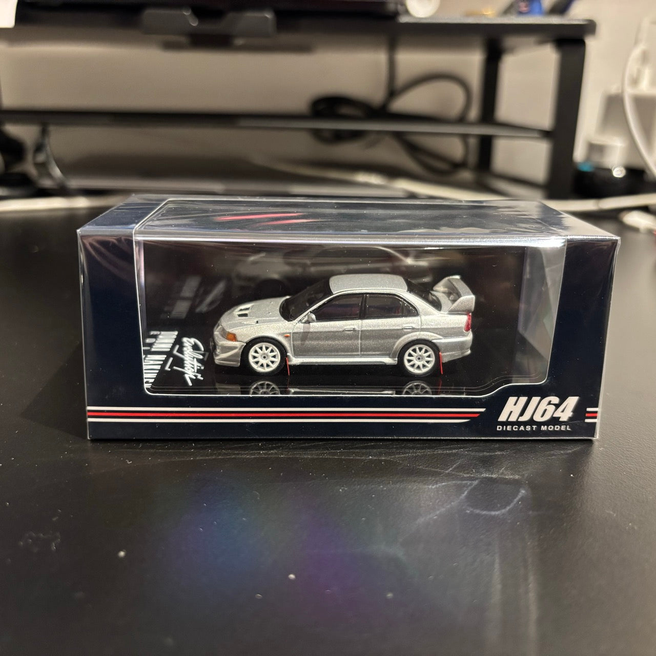 Hobby Japan 1:64 MITSUBISHI LANCER GSR EVOLUTION 6 (T.M.E) (CP9A) 2000 with Mud flap Satellite Silver (M) Official Licensed (HJ642033BS)