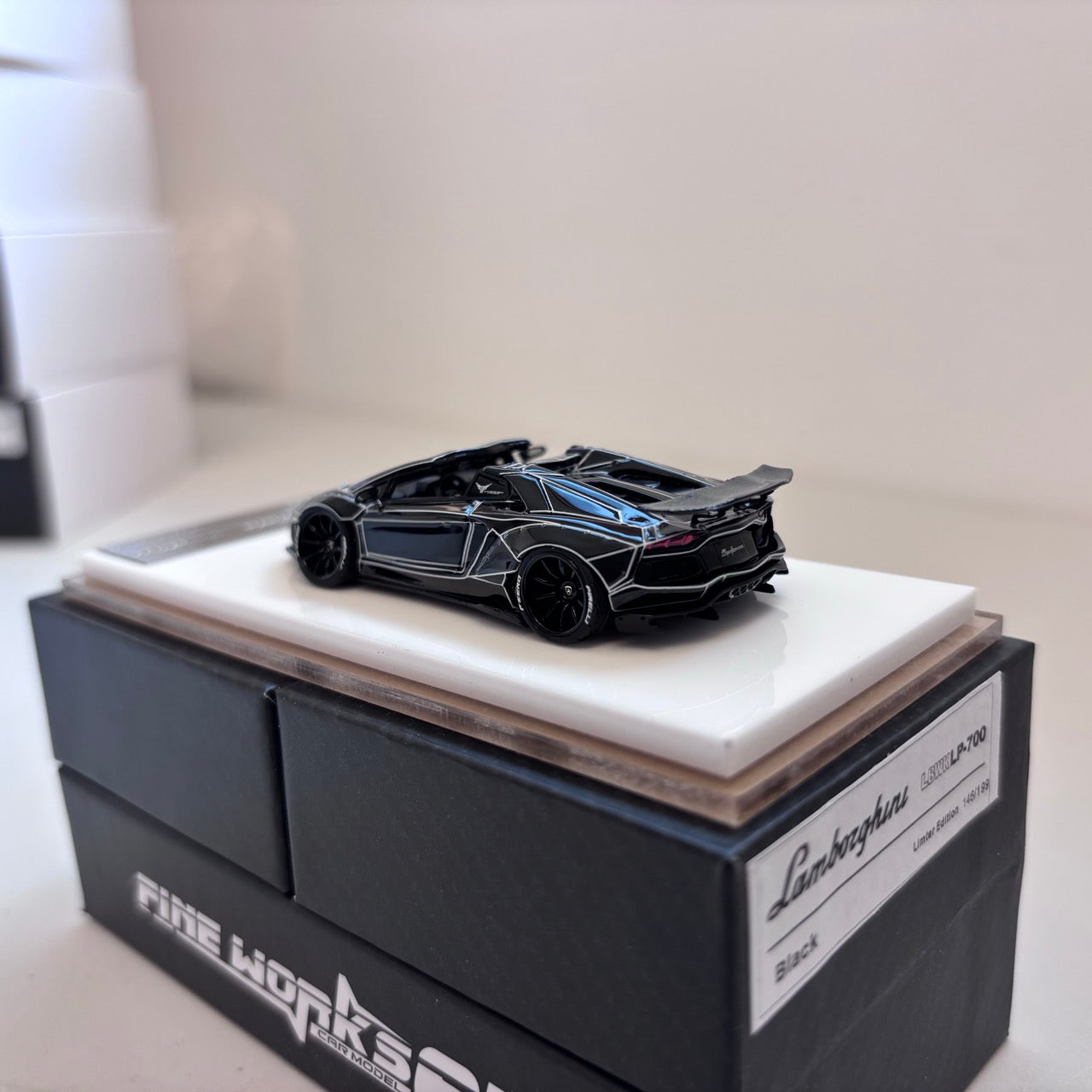 [3 Cars Bundle] Mini GT 1:64 Porsche 911 GT3 R #77 AO Racing 2025 IMSA Petit Le Mans in Paper Box Packaging (MGT01143-CH)  + [Premium Resin Model] Fine Works 1:64 Aventador LP700-4 Black White Panel Lines+ Fine Works 1:64 Camaro Transformers White