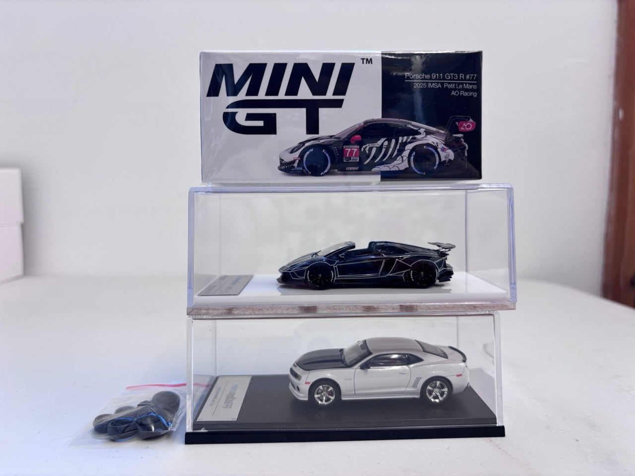 [3 Cars Bundle] Mini GT 1:64 Porsche 911 GT3 R #77 AO Racing 2025 IMSA Petit Le Mans in Paper Box Packaging (MGT01143-CH)  + [Premium Resin Model] Fine Works 1:64 Aventador LP700-4 Black White Panel Lines+ Fine Works 1:64 Camaro Transformers White
